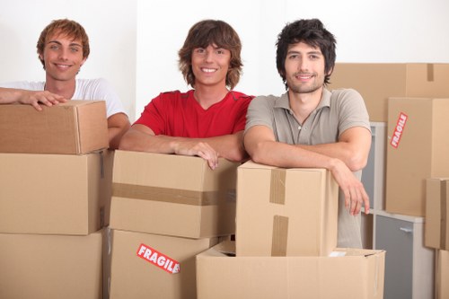 Professional movers unloading items at a Brondesbury flat